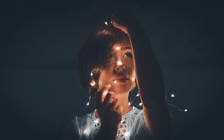 girl wrapped in fairy lights