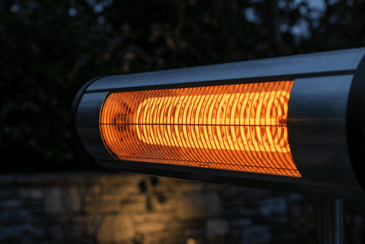 Close-up of an electric infrared patio heater element glowing warm orange