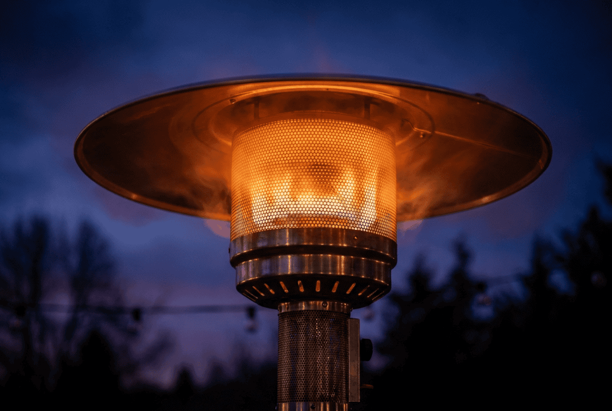 Close-up of a patio heater emitter head glowing with radiant heat
