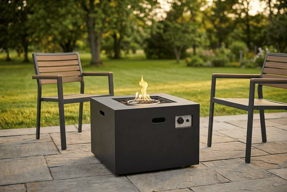Kinger Home Kai 32-inch square propane fire pit table lit on a stone patio at golden hour